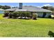 A well-maintained back yard with lush landscaping, a screened-in porch, and seating at 109 Lake Mariam Way, Winter Haven, FL 33884