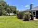 A well-maintained back yard with a privacy fence, lush landscaping, and a screened-in porch at 109 Lake Mariam Way, Winter Haven, FL 33884