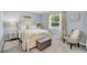 Charming bedroom with a four-poster bed, soft lighting, and a view to a landscaped yard at 109 Lake Mariam Way, Winter Haven, FL 33884