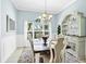 Dining room featuring a chandelier and built in shelving for storage and display at 109 Lake Mariam Way, Winter Haven, FL 33884