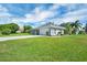 Charming one story home with a manicured lawn, paver driveway, and mature landscaping at 109 Lake Mariam Way, Winter Haven, FL 33884