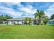 Beautiful home with a meticulously maintained lawn, lush tropical landscaping, and a welcoming front facade under a sunny sky at 109 Lake Mariam Way, Winter Haven, FL 33884