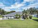 Beautiful home with a meticulously maintained lawn, lush tropical landscaping, and a welcoming front facade under a sunny sky at 109 Lake Mariam Way, Winter Haven, FL 33884