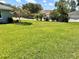 A lush, well-maintained front yard with mature trees and landscaping at 109 Lake Mariam Way, Winter Haven, FL 33884