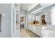 Hallway with views into the main bathroom, closet, and main bedroom at 109 Lake Mariam Way, Winter Haven, FL 33884