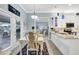 Open kitchen and dining area with stainless steel appliances, granite countertops, and white cabinetry at 109 Lake Mariam Way, Winter Haven, FL 33884