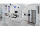 Stylish kitchen with white cabinets, modern stainless steel appliances, and attractive countertops at 109 Lake Mariam Way, Winter Haven, FL 33884