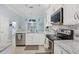 Bright, modern kitchen with stainless steel appliances and white cabinetry offering ample counter space at 109 Lake Mariam Way, Winter Haven, FL 33884