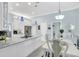 Light-filled kitchen featuring a spacious island, modern appliances, and a combined dining area at 109 Lake Mariam Way, Winter Haven, FL 33884