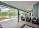 Relax on this covered patio with comfortable seating, a ceiling fan, and scenic views at 109 Lake Mariam Way, Winter Haven, FL 33884