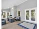 Inviting screened lanai with a fire pit, comfortable seating, and tiled flooring for relaxing outdoors at 109 Lake Mariam Way, Winter Haven, FL 33884