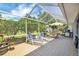 Enjoy the outdoors on this screened lanai with lounge chairs and an umbrella-covered dining set at 109 Lake Mariam Way, Winter Haven, FL 33884
