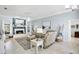 Bright living room with fireplace, tile floors, and beach-themed decor at 109 Lake Mariam Way, Winter Haven, FL 33884