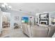 Open living room with fireplace, beach decor, view of dining room, and lots of seating at 109 Lake Mariam Way, Winter Haven, FL 33884