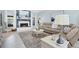 Bright living room with fireplace, tile floors, and beach-themed decor at 109 Lake Mariam Way, Winter Haven, FL 33884