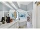 Bright bathroom with double sinks, a soaking tub, and lots of natural light from the skylights at 109 Lake Mariam Way, Winter Haven, FL 33884
