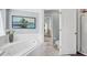 This bright bathroom features a whirlpool tub, and an adjacent toilet and shower area at 109 Lake Mariam Way, Winter Haven, FL 33884