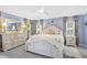 Elegant main bedroom with light blue walls, a white four-poster bed, and matching dresser at 109 Lake Mariam Way, Winter Haven, FL 33884