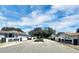 Community street view with Lake Marian Hills entrance signs and well-maintained landscaping under a blue sky at 109 Lake Mariam Way, Winter Haven, FL 33884