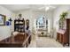 Bright and airy home office featuring a wooden desk, comfortable seating, and a large window at 109 Lake Mariam Way, Winter Haven, FL 33884