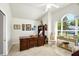 Home office with a wooden desk, chair, bookcase, and a large window offering natural light at 109 Lake Mariam Way, Winter Haven, FL 33884