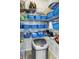 Organized pantry with wire shelving filled with blue baskets and food items with a stainless steel trashcan at 109 Lake Mariam Way, Winter Haven, FL 33884