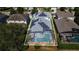 Aerial view of home with solar panels and screened in pool, surrounded by neighboring houses at 110 Minniehaha Cir, Haines City, FL 33844