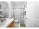 A clean and functional bathroom, with a toilet, shower with curtain and a sink at 110 Minniehaha Cir, Haines City, FL 33844