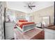This bedroom features stylish, light-tone walls, ceiling fan and hardwood floors at 110 Minniehaha Cir, Haines City, FL 33844