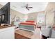 This primary bedroom features hardwood flooring, a ceiling fan and a mirror at 110 Minniehaha Cir, Haines City, FL 33844