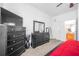 This bedroom offers two black dressers and a TV with access to the en-suite bathroom at 110 Minniehaha Cir, Haines City, FL 33844