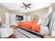Comfortable primary bedroom features stylish hardwood flooring, ceiling fan and an en-suite bathroom at 110 Minniehaha Cir, Haines City, FL 33844