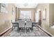 Elegant dining room features a table with six chairs, artwork, and a large window for natural light at 110 Minniehaha Cir, Haines City, FL 33844
