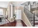 Welcoming foyer with hardwood floors, a staircase, and a view into the living space at 110 Minniehaha Cir, Haines City, FL 33844