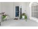 Cozy front porch with decorative plants, a welcome sign, and a view of the entrance at 110 Minniehaha Cir, Haines City, FL 33844