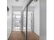 Well-lit hallway featuring mirrored closet doors and views into the bathrooms at 110 Minniehaha Cir, Haines City, FL 33844