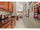 Hallway featuring kitchen bar and dining area, leading to wall with decorative artwork at 110 Minniehaha Cir, Haines City, FL 33844