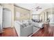 Open-concept living room with a large sectional sofa, hardwood floors, and decorative wall art at 110 Minniehaha Cir, Haines City, FL 33844