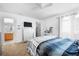 Comfortable bedroom with a bed, dresser, TV, and natural light at 110 Minniehaha Cir, Haines City, FL 33844