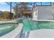 Inviting in-ground pool with attached spa, net, umbrella, and lounge chairs for relaxation at 110 Minniehaha Cir, Haines City, FL 33844