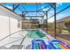 Relaxing screened-in pool with inviting patio, lounge chairs, and a clear blue sky at 110 Minniehaha Cir, Haines City, FL 33844