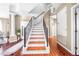 This beautiful staircase features hardwood flooring and iron railings at 110 Minniehaha Cir, Haines City, FL 33844
