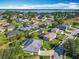 Beautiful aerial view of a neighborhood with mature trees and well-maintained lawns and homes near a lake at 123 Evergreen Dr, Auburndale, FL 33823