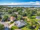 A scenic aerial view of a home and the community shows the proximity to a serene lake at 123 Evergreen Dr, Auburndale, FL 33823