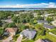 Breathtaking aerial view of the lake neighborhood, featuring lush trees and blue sky at 123 Evergreen Dr, Auburndale, FL 33823