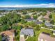 Stunning aerial view showcasing the neighborhood's lush greenery and the serene lake at 123 Evergreen Dr, Auburndale, FL 33823