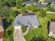 Aerial shot of a well-maintained property, showcasing the pool and green lawn at 123 Evergreen Dr, Auburndale, FL 33823