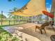Paver patio in the backyard with sunshade, perfect for relaxation and outdoor gatherings at 123 Evergreen Dr, Auburndale, FL 33823