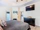 Spacious bedroom with a flat-screen TV, a door to the outside, and ample closet space at 123 Evergreen Dr, Auburndale, FL 33823
