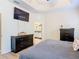 Bedroom featuring dark wood furniture, a TV, and an attached ensuite bathroom at 123 Evergreen Dr, Auburndale, FL 33823
